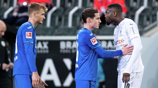 Soccer Football - Bundesliga - Borussia Moenchengladbach v TSG 1899 Hoffenheim - Borussia-Park, Moenchengladbach, Germany - December 19, 2020 Borussia Moenchengladbach's Marcus Thuram and TSG 1899 Hoffenheim's Stefan Posch clash Pool via REUTERS/Marius Becker DFL regulations prohibit any use of photographs as image sequences and/or quasi-video.