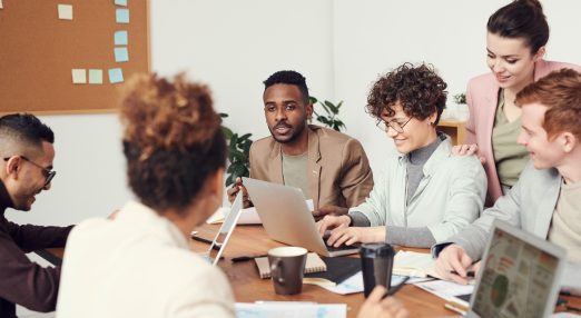 A group of colleagues sitting at a working table