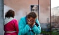 A woman reacts in the courtyard of a damaged building following a missile attack at an undisclosed location in Odesa region.