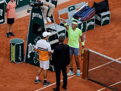 Nishikori y Nadal hablan con el supervisor antes de la suspensión, este martes en París.