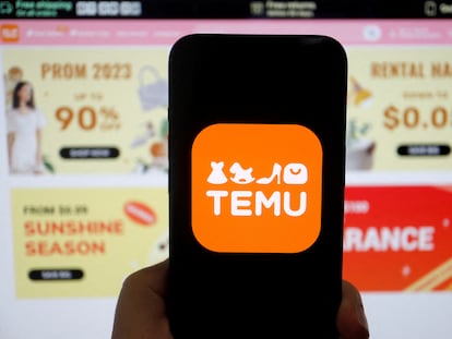 FILE PHOTO: The logo of Temu, an e-commerce platform owned by PDD Holdings, is seen on a mobile phone displayed in front of its website, in this illustration picture taken April 26, 2023. REUTERS/Florence Lo/Illustration/File Photo