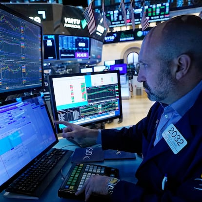 FILE - Specialist James Denaro works at his post on the floor of the New York Stock Exchange, Wednesday, Nov. 15, 2023. Stocks edged higher in morning trading on Wall Street Wednesday, Nov. 29, following some encouraging updates from U.S. companies, including General Motors. (AP Photo/Richard Drew, File)