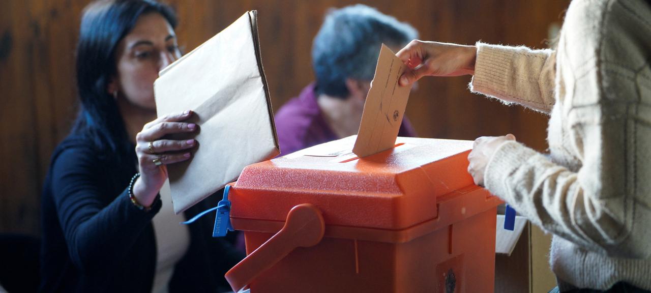 Eine Frau wirft in einem Wahllokal in Montevideo ihren Wahlzettel in eine Wahlurne