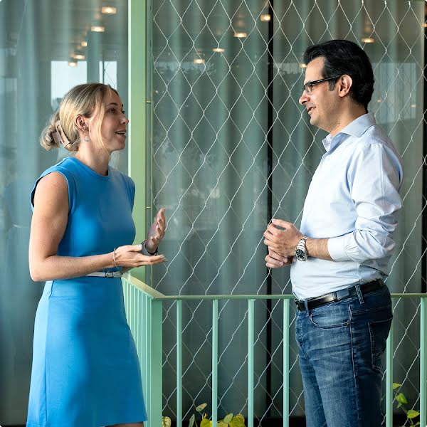 Jennifer Wadsworth, Leiterin der Forschungskoordination des Zentrums für Künstliche Intelligenz (AI Center) an der Eidgenössischen Technischen Hochschule (ETH) in Zürich, und Beshad Behzadi, Vice President Produktentwicklung bei Google Cloud in der Schweiz, diskutieren im Stehen miteinander.