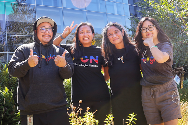 Four Googlers pose outside a Google office