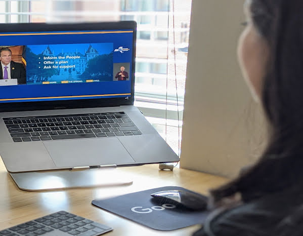 A profile shot of a woman looking at a computer screen.