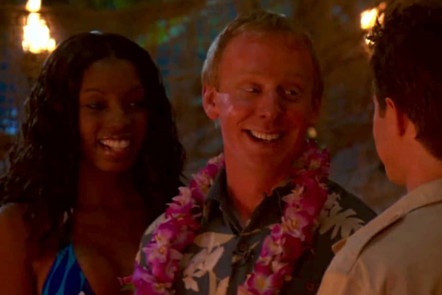 the man smiling with a beautiful woman in a bikini