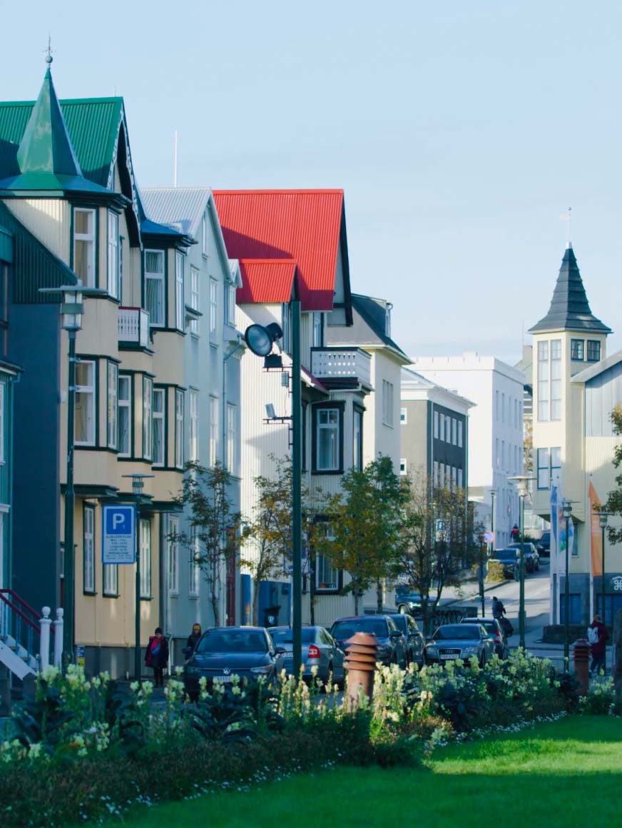 city street in Iceland across from a green park